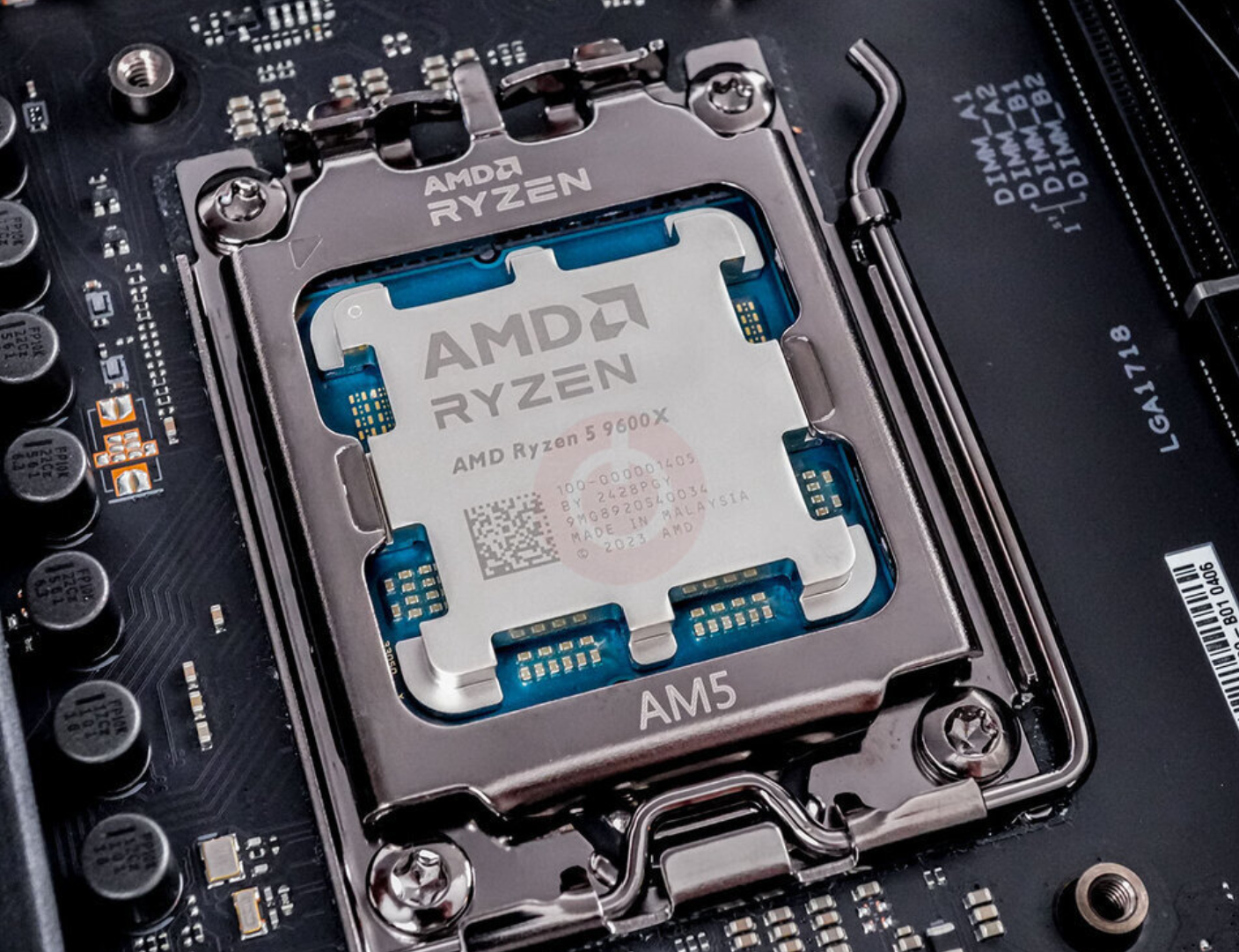 On Demand AMD Ryzen R5 9600X Processor 6 cores and 12 threads - installed in an AM5 motherboard socket, showing the metal heat spreader with engraved branding and text.
