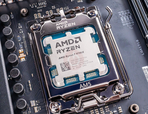 On Demand AMD Ryzen R7 9700X Processor 8 cores and 16 threads - installed in an AM5 motherboard socket, showing the silver metal heat spreader with engraved branding and text.
