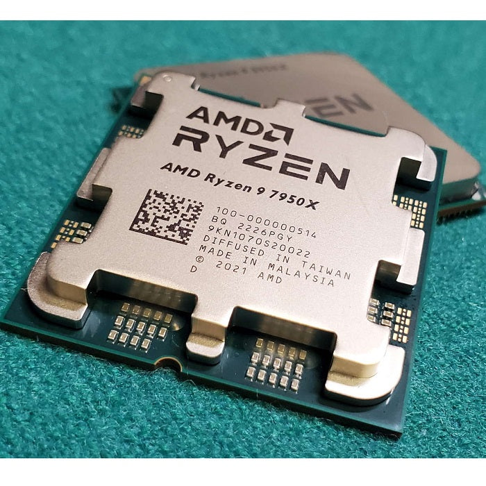 On Demand AMD Ryzen R9 7950X 16 cores and 32 threads Processor High-Performance AMD CPU for Gaming & Workstations - a close-up of the gold-coloured metal heat spreader with laser-etched branding and serial numbers, set on a textured green surface.