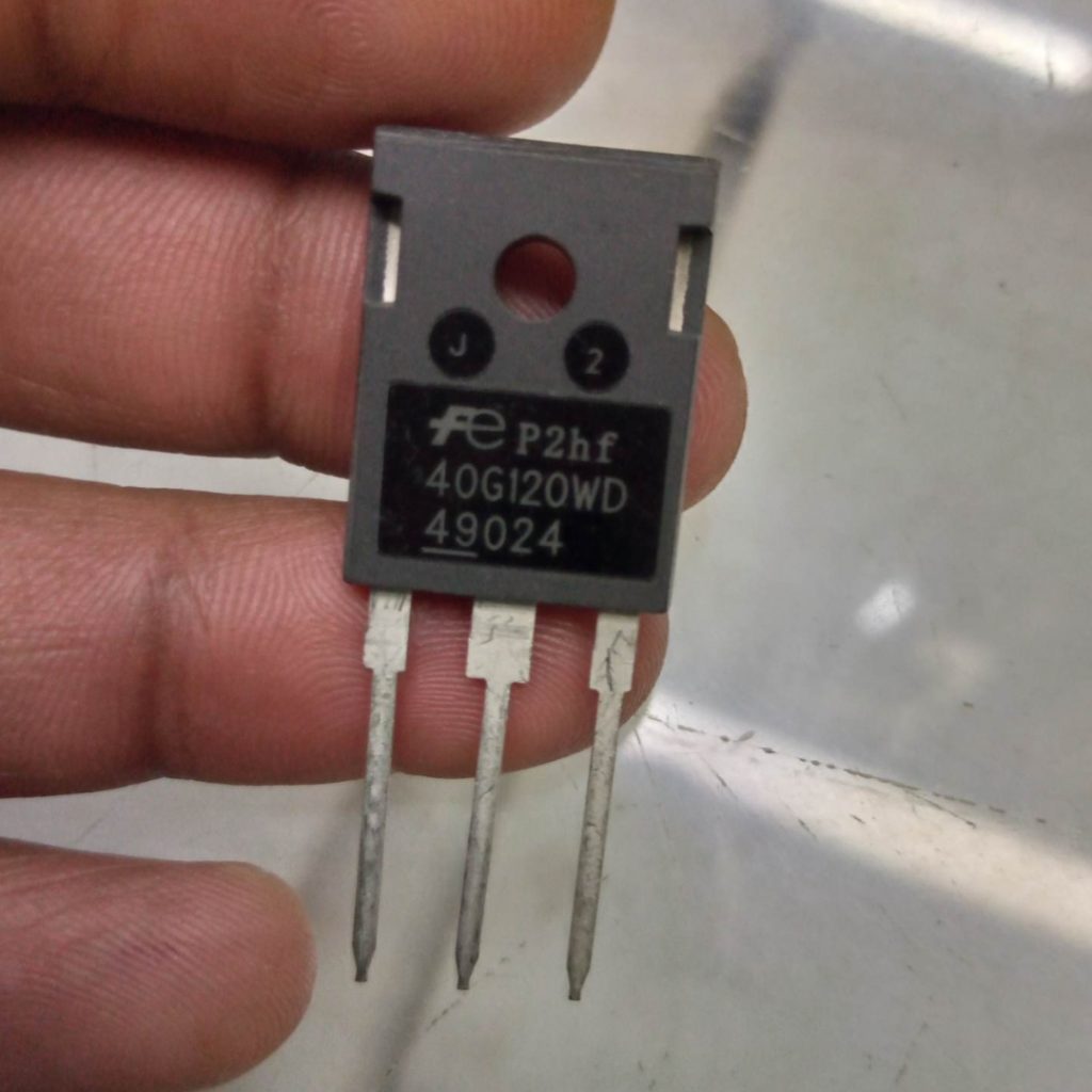 On Demand Used FGH 40T120 IGBT (40A 1200V) - Buy Online At Digilog.pk - a grey three-pin electronic component held by fingers, showing the text "P2hf 40G120WD 49024" printed on its face.