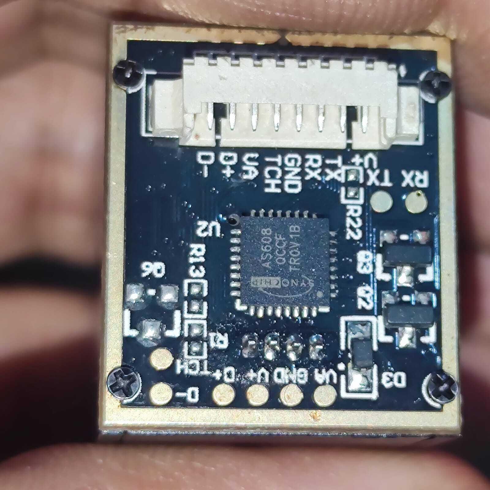 Optical Fingerprint Reader Sensor Module JM-101B 1816C - Buy At Digilog.pk - a close-up of the blue circuit board showing the Synochip AS608 IC and a white connector port.