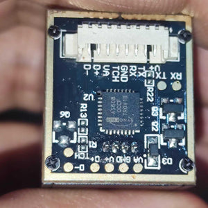 Optical Fingerprint Reader Sensor Module JM-101B 1816C - Buy At Digilog.pk - a close-up of the blue circuit board showing the Synochip AS608 IC and a white connector port.