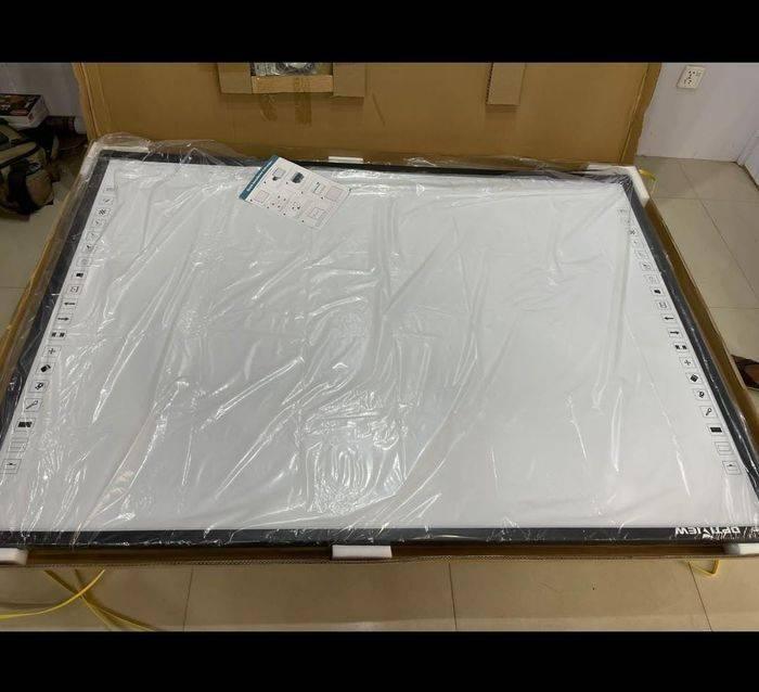 Optiview Interactive Whiteboard Touchable Display 82 Inch Size Working With Projector OPV-WB82 - a large rectangular white touch-sensitive display with black side control buttons, shown inside its box.