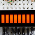 Orange 10 Segment Light Bar Graph LED Display - ten illuminated orange rectangular LED segments mounted on a breadboard with wires and resistors.