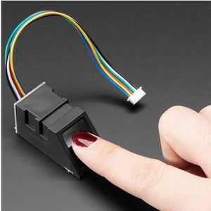 Original Finger Print Sensor R307 Optical Finger Print Scanner Reader Module - a black optical scanner module with a multi-coloured ribbon cable, being tested by a finger.