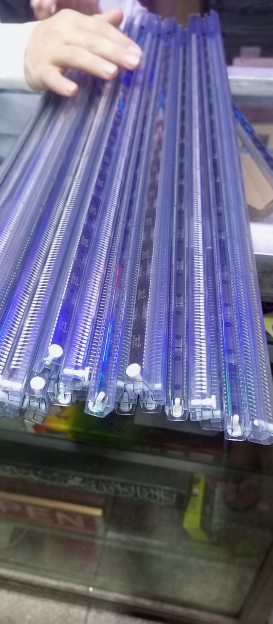Original Inverter IC DSPIC30F2010 Microcontroller Price - shown as a collection of multiple units in long, clear plastic protective tubes held by a hand.