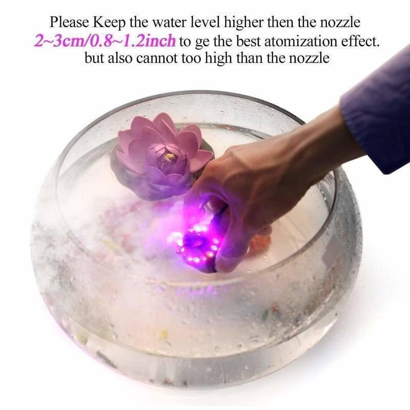 Original Ultrasonic Mist Maker Fogger 12 LED Colorful Light 24V 2A Humidifier - being held in a glass bowl of water with a decorative floating flower.