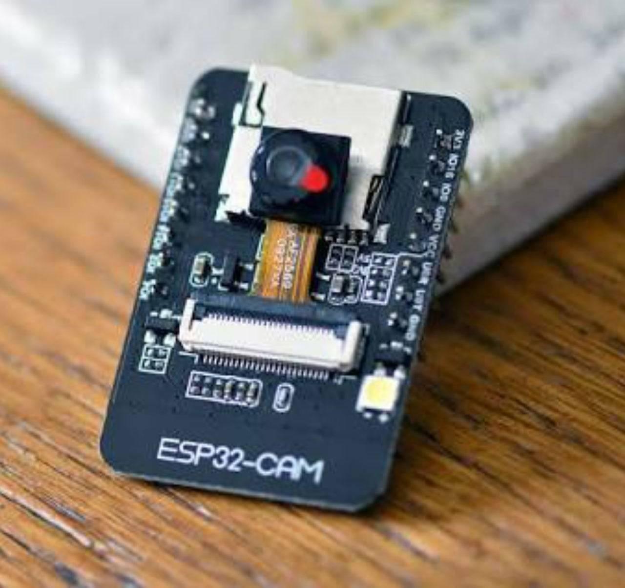 OV3660 ESP32-CAM WiFi + Bluetooth Camera Module Development Board ESP32 With Camera Module OV2640 For Arduino - a black rectangular development board with a central camera lens, a white ribbon cable connector, and an LED.