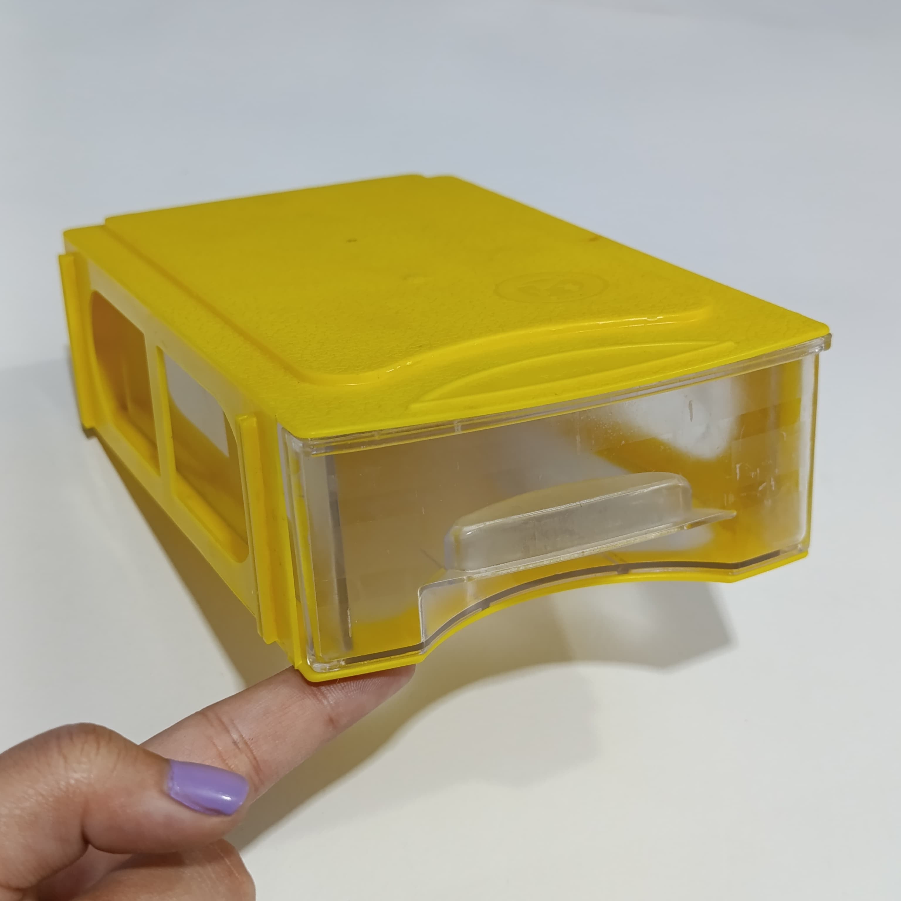P-106 175MMX108MMX50MM Drawer For Storage Organizer Box - a single yellow plastic storage drawer with a clear front panel held by a hand.