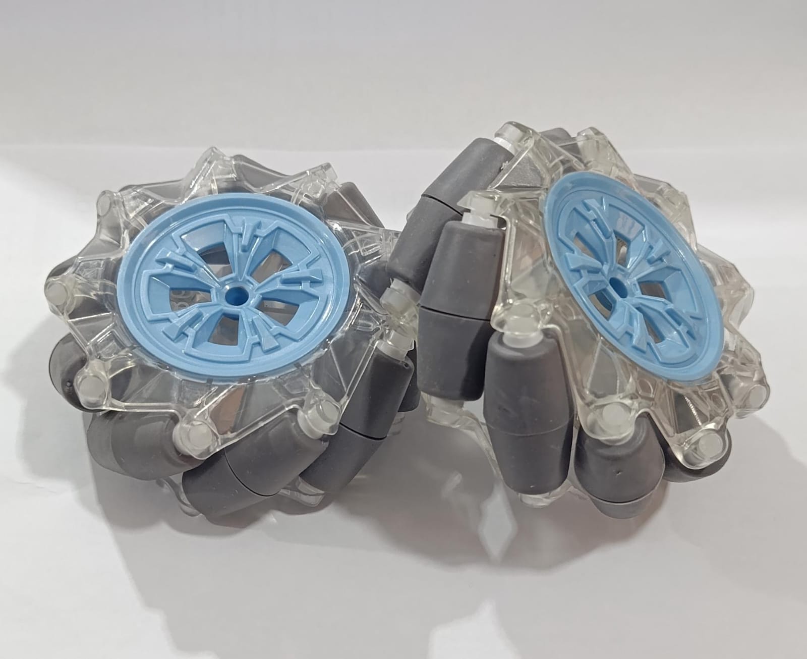 (Pair Left + Right) 95mm Mecanum Omni-directional Wheels - with clear plastic frames, light blue centers, and grey rubber rollers.