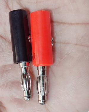 Pair of 4mm Banana Plugs - shown as a close-up of one black and one red connector held in a hand.