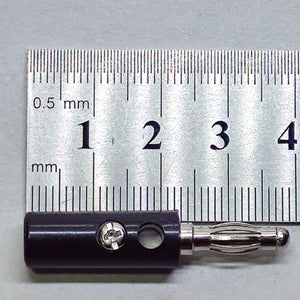 Pair of 4mm Banana Plugs - a black connector with a metal contact and screw terminal, shown in a close-up against a metal ruler for scale.