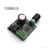 PAM8610 With Volume 12V Dual-channel Digital Amplifier Board Stereo Audio Amplifier Board 15W * 2 - a black circuit board, a large cylindrical capacitor, a volume control knob, a power jack, and screw terminals.