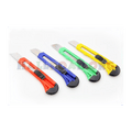 Paper Cutter Or Pocket Cutter Knife - shown as four plastic utility knives in red, blue, green, and yellow, each with a retractable blade and black slider.