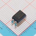Pc817 Photocopier Opto Isolator - a black four-pin electronic component resting on a blue grid background.