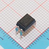 Pc817 Photocopier Opto Isolator - a black four-pin electronic component resting on a blue grid background.