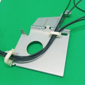 PCB Inserting Hole Cable Clamp, Body PCB Inserting Cable Clamps - two white plastic cable clips holding black wires attached to a silver metal mounting plate on a green surface.
