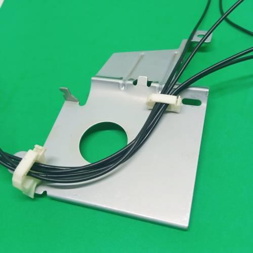 PCB Inserting Hole Cable Clamp, Body PCB Inserting Cable Clamps - two white plastic cable clips holding black wires attached to a silver metal mounting plate on a green surface.