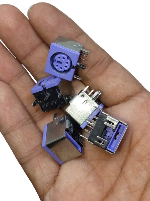 PCB Mount 6 Pin Mini DIN Socket Audio Video Connector - shown as a hand holding several purple and silver metal connectors with circular and rectangular ports.