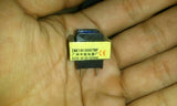 PCB Mount Current Transformer Current Sensor - a small yellow rectangular electronic component with two metal pins held in a hand.