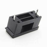 PCB Mount Fuse Holder 5mm x 20mm - a black plastic rectangular component with two metal pins protruding from the top.