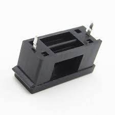 PCB Mount Fuse Holder 5mm x 20mm - a black plastic rectangular component with two metal pins protruding from the top.