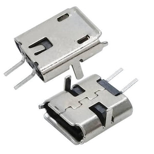 PCB Mount Micro USB Connector - two silver-coloured metal micro USB female ports with through-hole mounting pins angled for circuit board assembly.