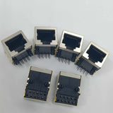 PCB Mount RJ45 Ethernet Connector - six silver and black metal-shielded modular jacks with exposed pins arranged on a white surface.