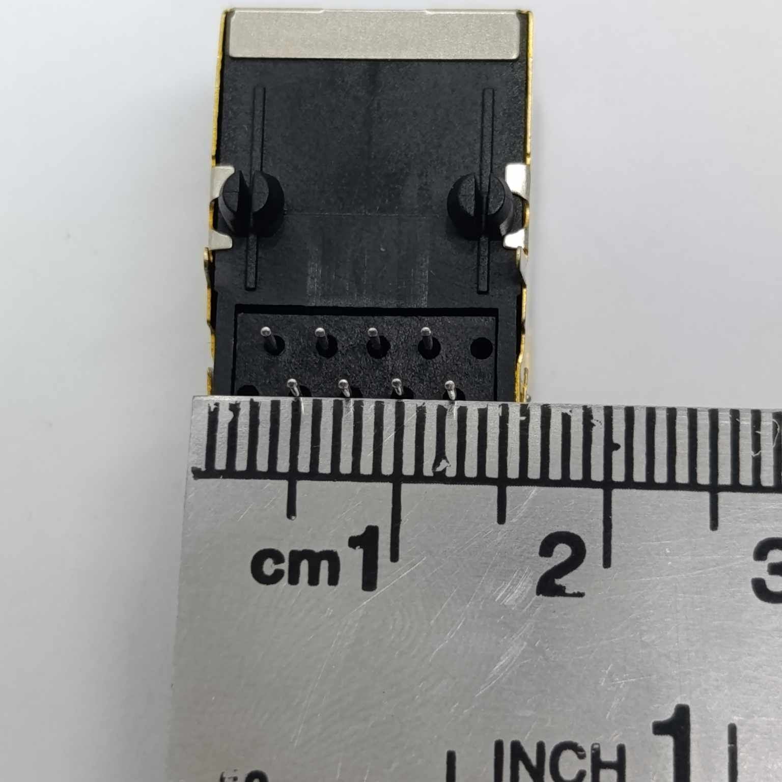 PCB Mount RJ45 Ethernet Connector - shown from the top, featuring a black plastic housing with metal shielding and pins, measured against a metal ruler.
