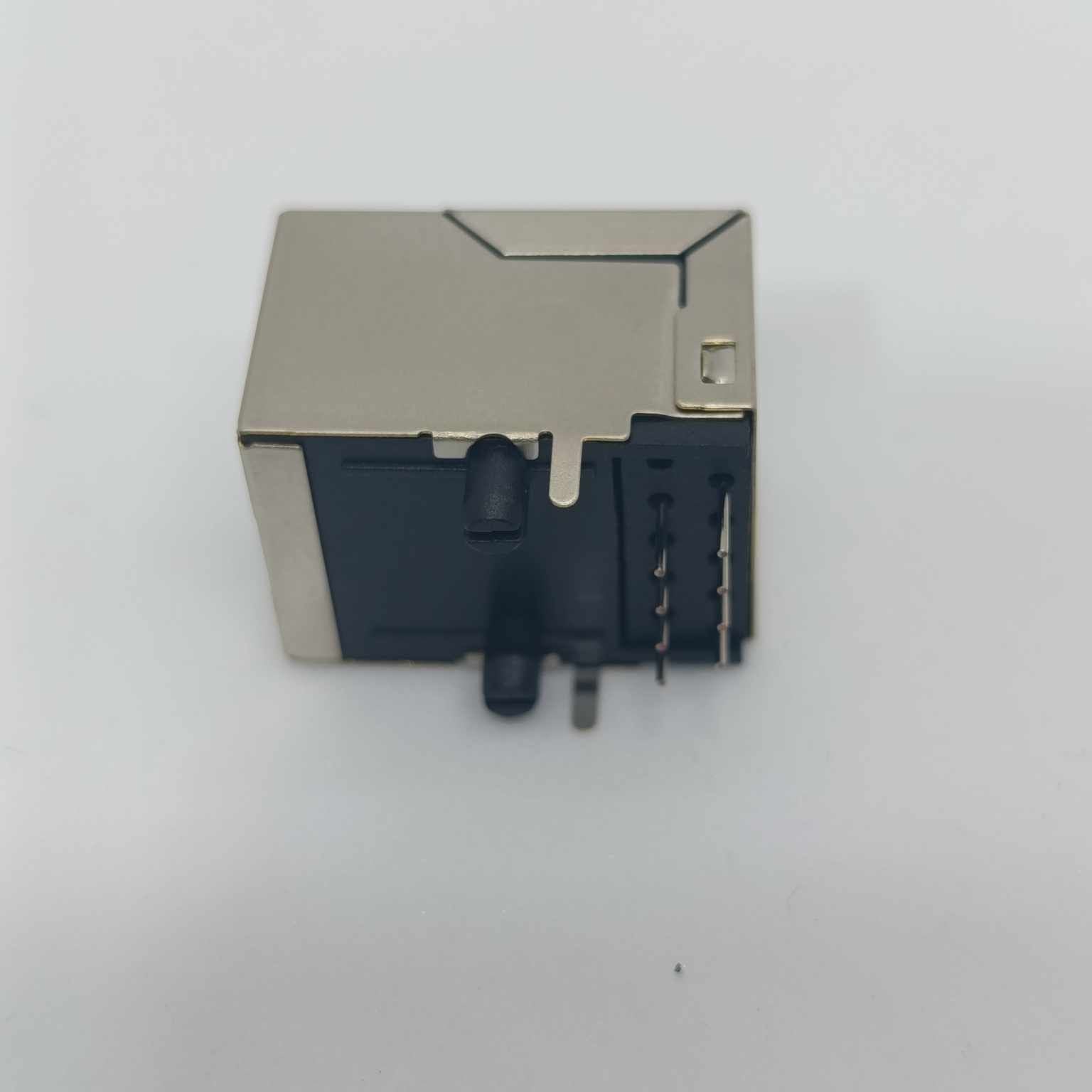 PCB Mount RJ45 Ethernet Connector - a silver metal-shielded rectangular housing with black plastic components and vertical pins on a white background.
