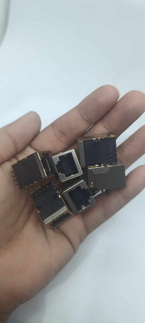 PCB Mount RJ45 Ethernet Connector - a handful of silver and black metal-shielded network ports held in a person's palm.