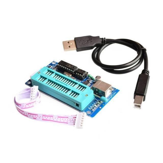 Pic K150 USB Pic Microcontroller Programmer - shown with a blue circuit board, a green ZIF socket, a USB cable, and a white ribbon cable.