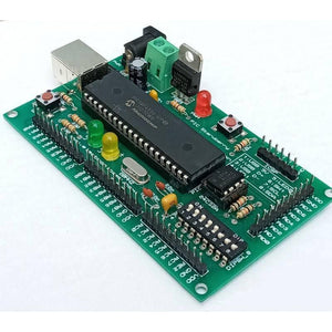 PIC Strawberry Microcontroller Development Board - a green PCB with a central PIC18F4550 chip, USB port, power jack, LEDs, and DIP switches.