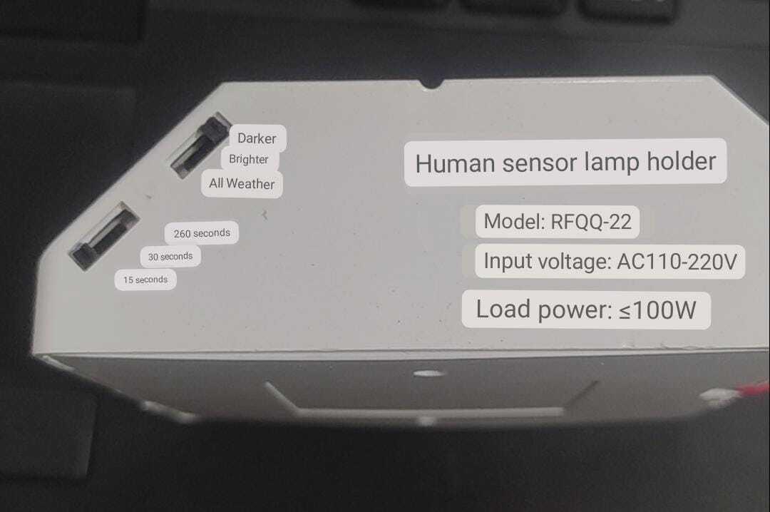 PIR Infrared Motion Sensor LED Lamp Wall Mounted Bulb Holder E27 AC220V - a white housing with two adjustment sliders and printed specifications.