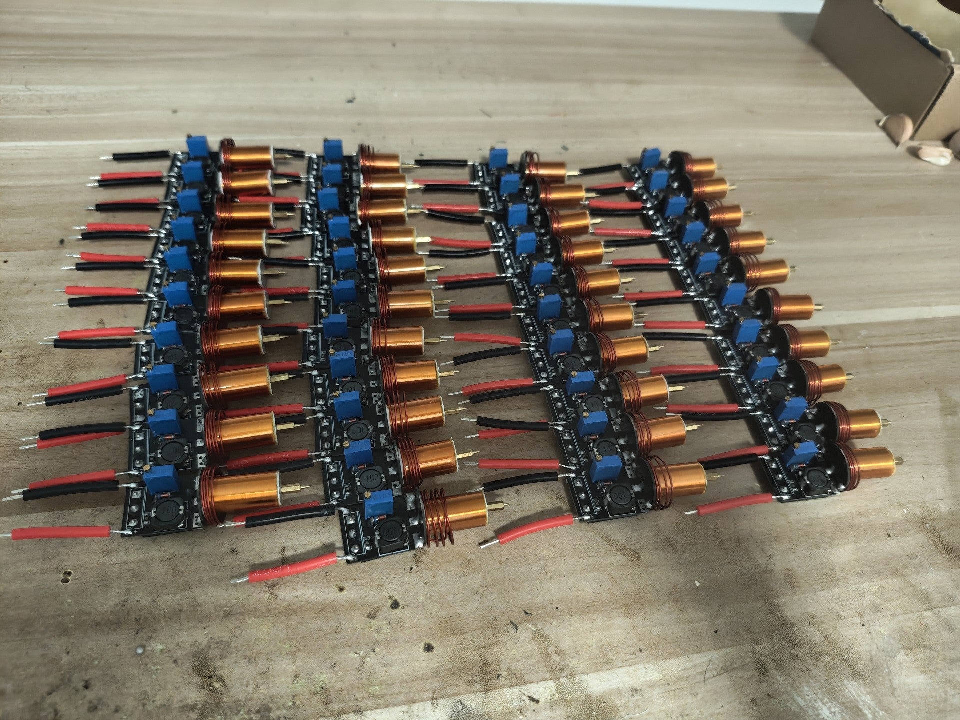 Plasma Arc Fire Head High-Frequency Electric Flame 15–24V Plasma Ignition Module-digilog.pk - shown as a bulk collection of black circuit boards with copper coils.