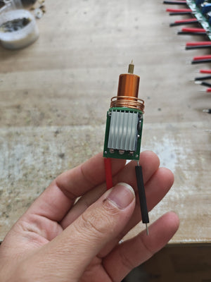 Plasma Arc Fire Head High-Frequency Electric Flame 15–24V Plasma Ignition Module-digilog.pk - a copper coil, a silver heatsink, and red and black power wires.