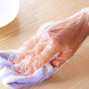 Plastic Surgical Disposable Hand Gloves - shown as a clear, thin plastic glove being worn on a hand while holding a purple and white striped cloth.