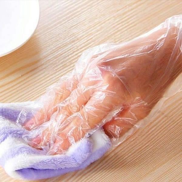 Plastic Surgical Disposable Hand Gloves - shown as a clear, thin plastic glove being worn on a hand while holding a purple and white striped cloth.