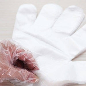 Plastic Surgical Disposable Hand Gloves - shown as a stack of thin, white, translucent plastic gloves with a hand partially inserting into the top one.