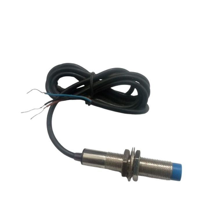 PNP Proximity Sensor - a cylindrical metal threaded body with a blue plastic tip and a black three-wire cable coiled behind it.