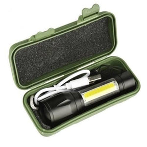Portable Mini 2 In 1 LED Flasht Light 1000 Lumens 3modes USB Rechargeable LED Torch Light - shown inside an open green plastic storage case with a white USB charging cable.