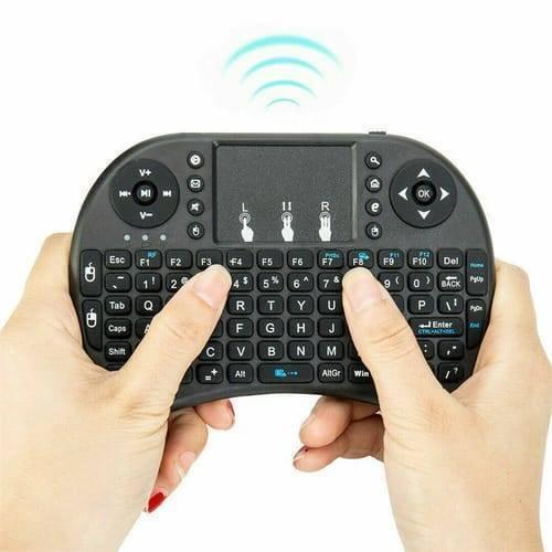 Portable Mini Wireless Keyboard Controller With Touchpad Mouse Combo And Backlight - held in two hands, showing the black QWERTY layout and touchpad.