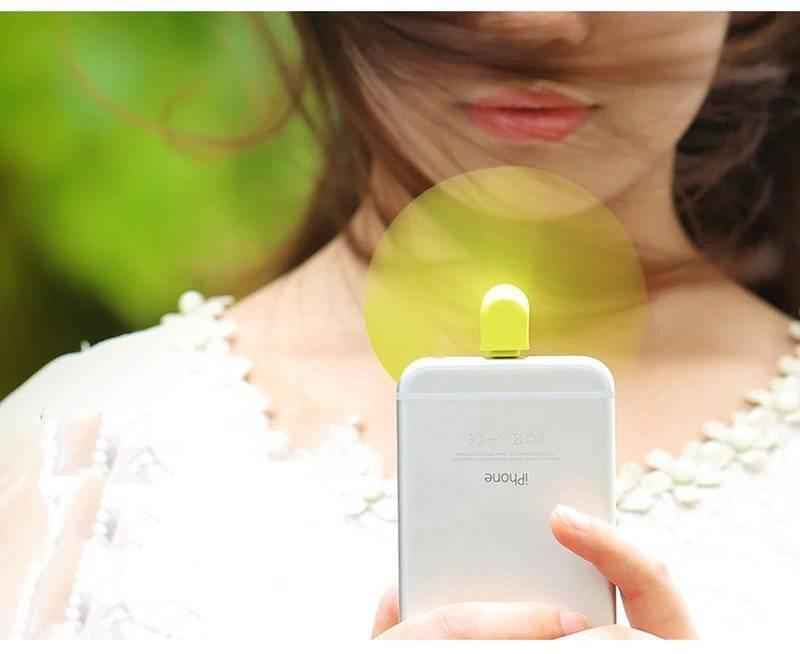 Portable USB Mini Fan For Iphone 5/5s/6/6s/6s Plus - shown as a small lime green fan attached to the charging port of a silver iPhone.