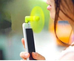 Portable USB Mini Fan For Iphone 5/5s/6/6s/6s Plus - shown in lime green plugged into the top of a white smartphone held by a person.