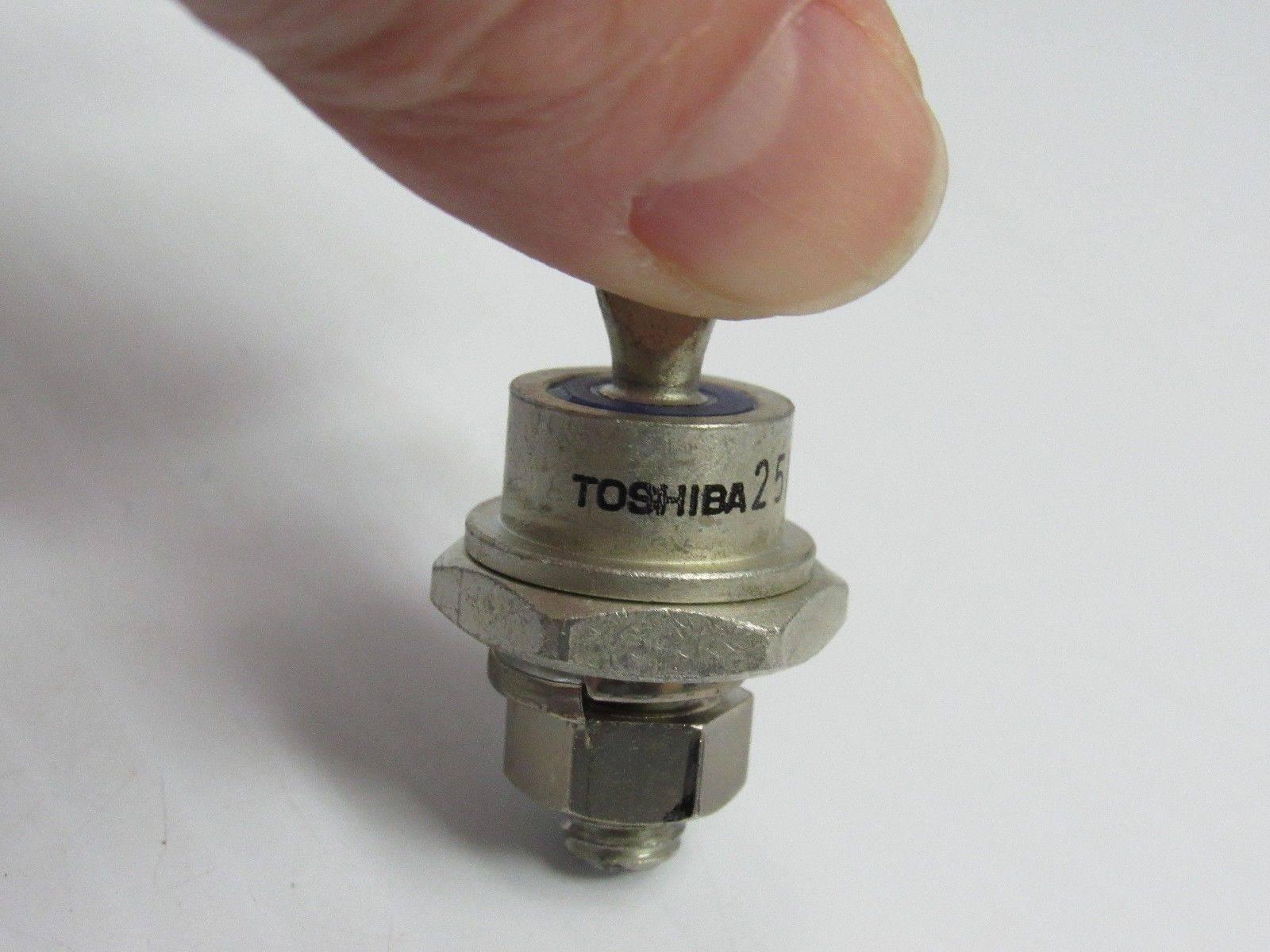 Power Diode 25A 1000V - held by fingers, showing a metallic stud-mount component with a threaded base, nut, and Toshiba branding printed on the side.