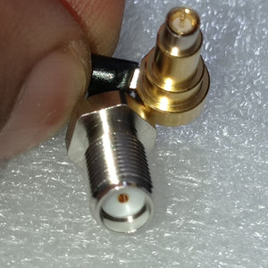 Pre Order RF RF Test Line MXHS83QE3000 Murata High Frequency C2 Test Line - a close-up showing a gold-coloured connector and a silver-coloured threaded connector joined by a black cable.