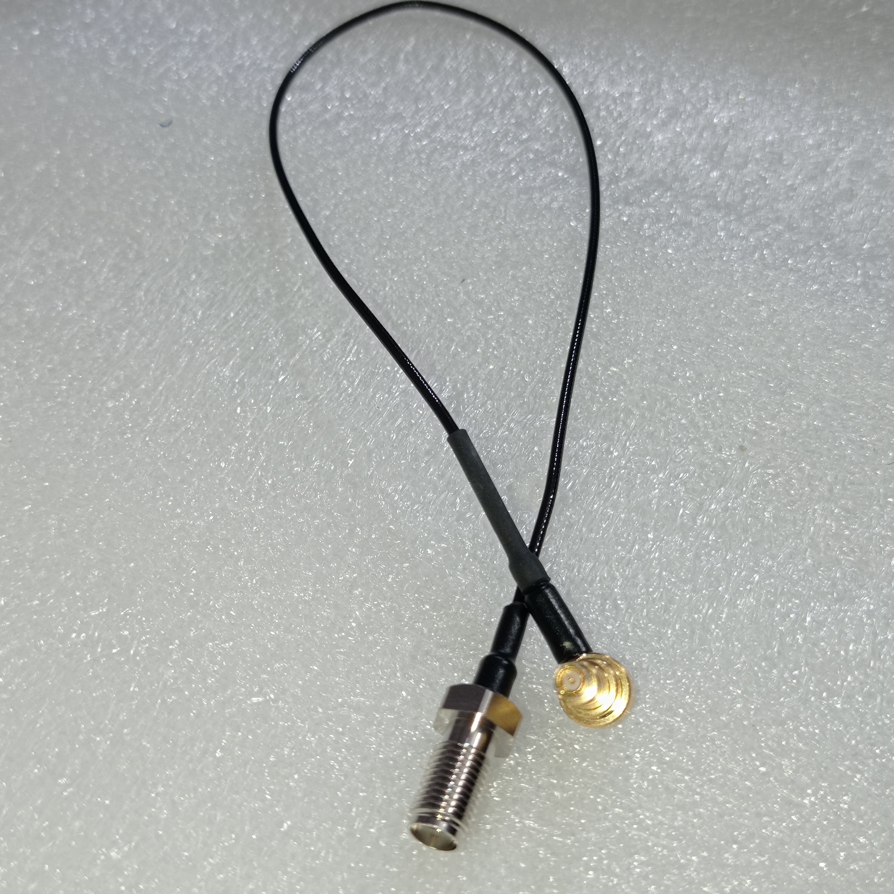 Pre Order RF RF Test Line MXHS83QE3000 Murata High Frequency C2 Test Line - a black coaxial cable with a threaded metal connector on one end and a gold circular connector.