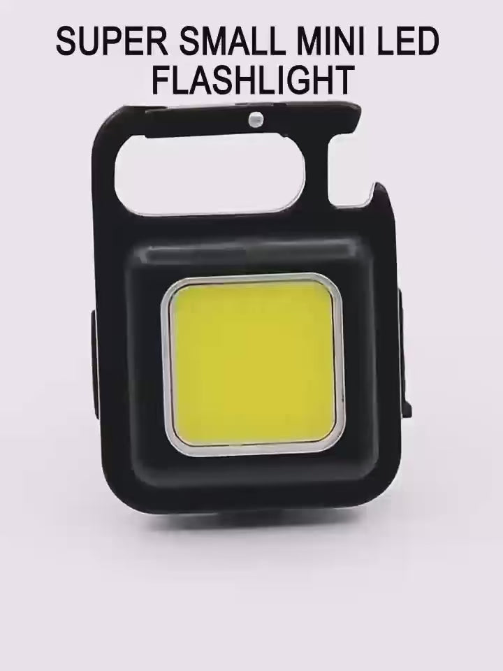 COB Rechargeable Keychain Flashlight | Mini Small Flashlight With 3 Light Modes, Folding Bracket, Bottle Opener, And Magnet Base For Fishing, Walking, - product video, preview showing a black square keychain light with a large yellow COB panel and bottle opener