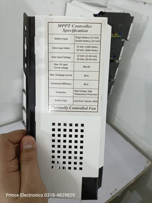 Prince 60A MPPT Solar Charge Controller With Wapda Option - a white rectangular device held in a hand, showing a printed specification label with technical details.