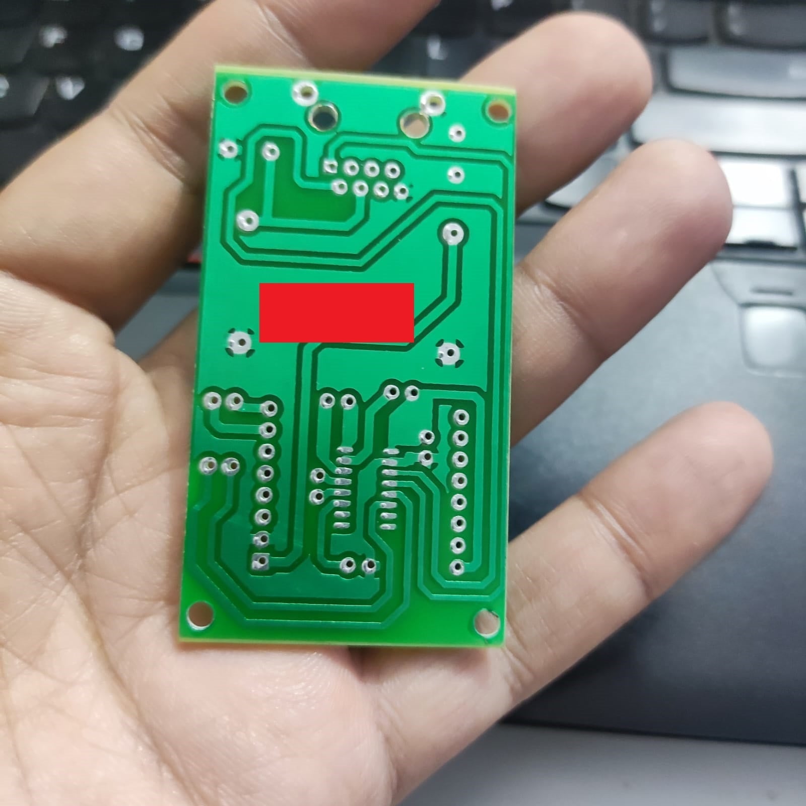 Private PCB For Specific Customer Do Not Order - rectangular green printed circuit board with copper traces and through-hole solder pads held in a hand.